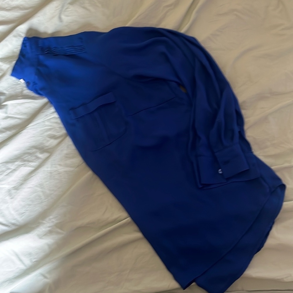Woman’s blouse. Long sleeve with buttons. Cute for work and works pants, flats.
